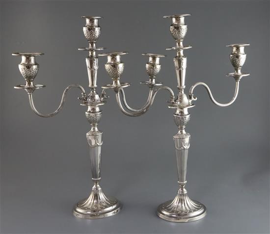 A pair of Edwardian silver two branch three light candelabra by Mappin & Webb, 48cm.